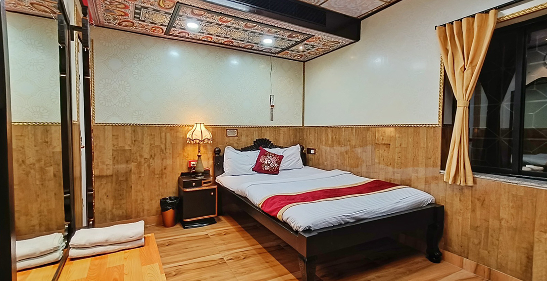 Luxurious bed setup in Singhis Room at House of Sheherwali Hotel in Azimganj, showcasing heritage-inspired decor and plush comfort