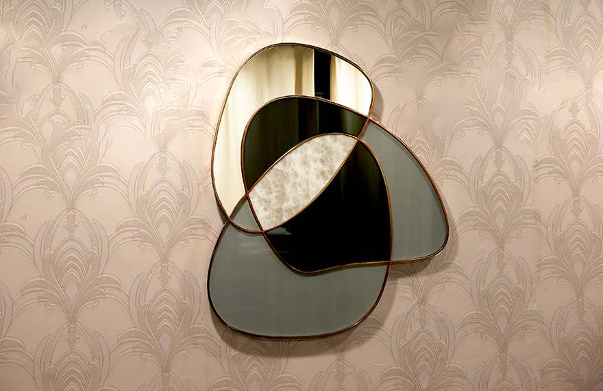 A display of mixed media artifacts combining wood, glass, metal, and carvings, showcasing Sheherwali heritage craftsmanship.