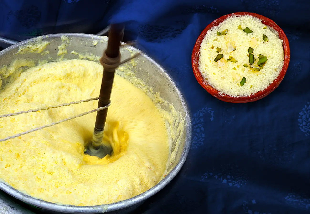 Close-up of Nimas, a delicate milk froth dessert served at House of Sheherwali in Azimganj, garnished with saffron