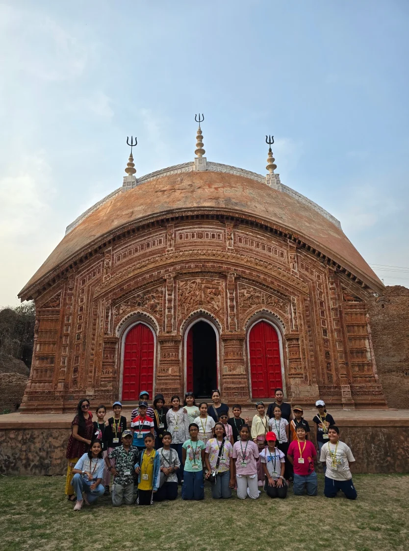 School students with ID lanyards outside the terracotta Char Bangla Temple with trident spires, Baranagar, Murshidabad