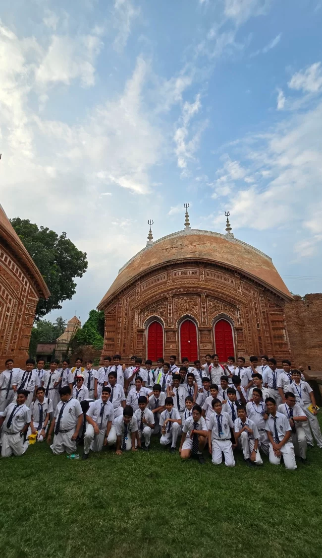 Students exploring the terracotta architecture of Char Bangla Temple in Murshidabad